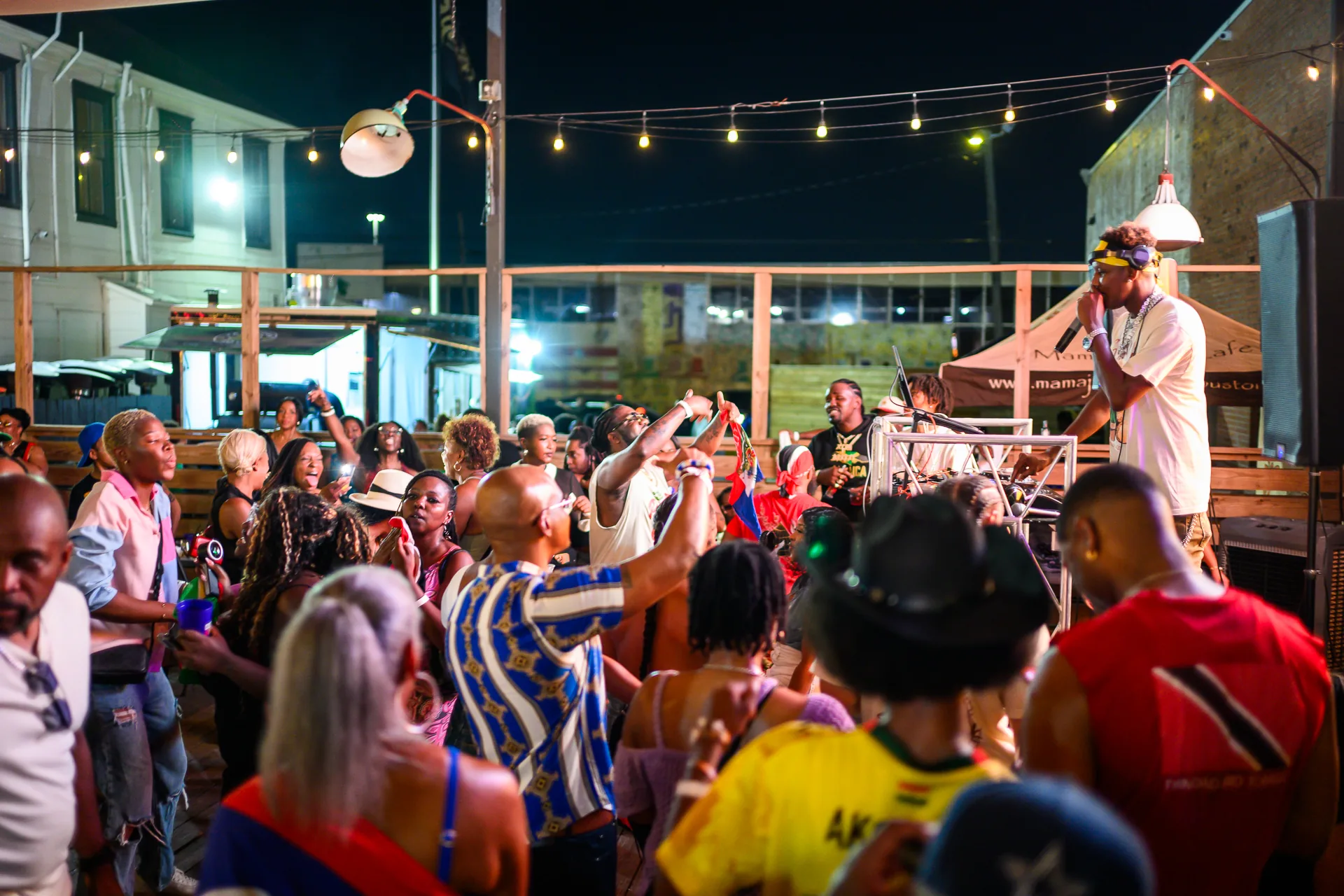 Guests gathering around the DJ in the outdoor venue at Culture & Tings.